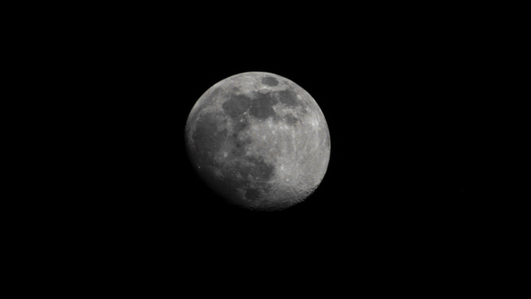 The moon brightly lit against the darkeness of space