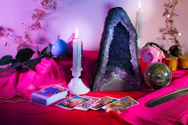 A lovely spread of tarot cards with candles and crystals