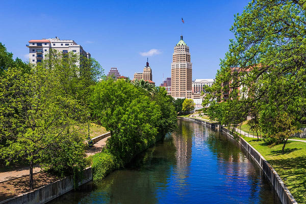 A lovely photo of the San Antonio river from south of downtown with part of the skyline visible