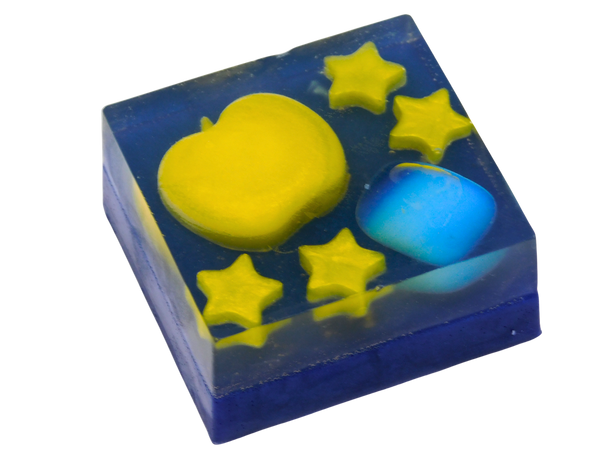 Opal Apple Soap angled view showing the deep navy blue square bar with yellow apple and star embeds on top alongside a rounded tumbled blue Opalite stone