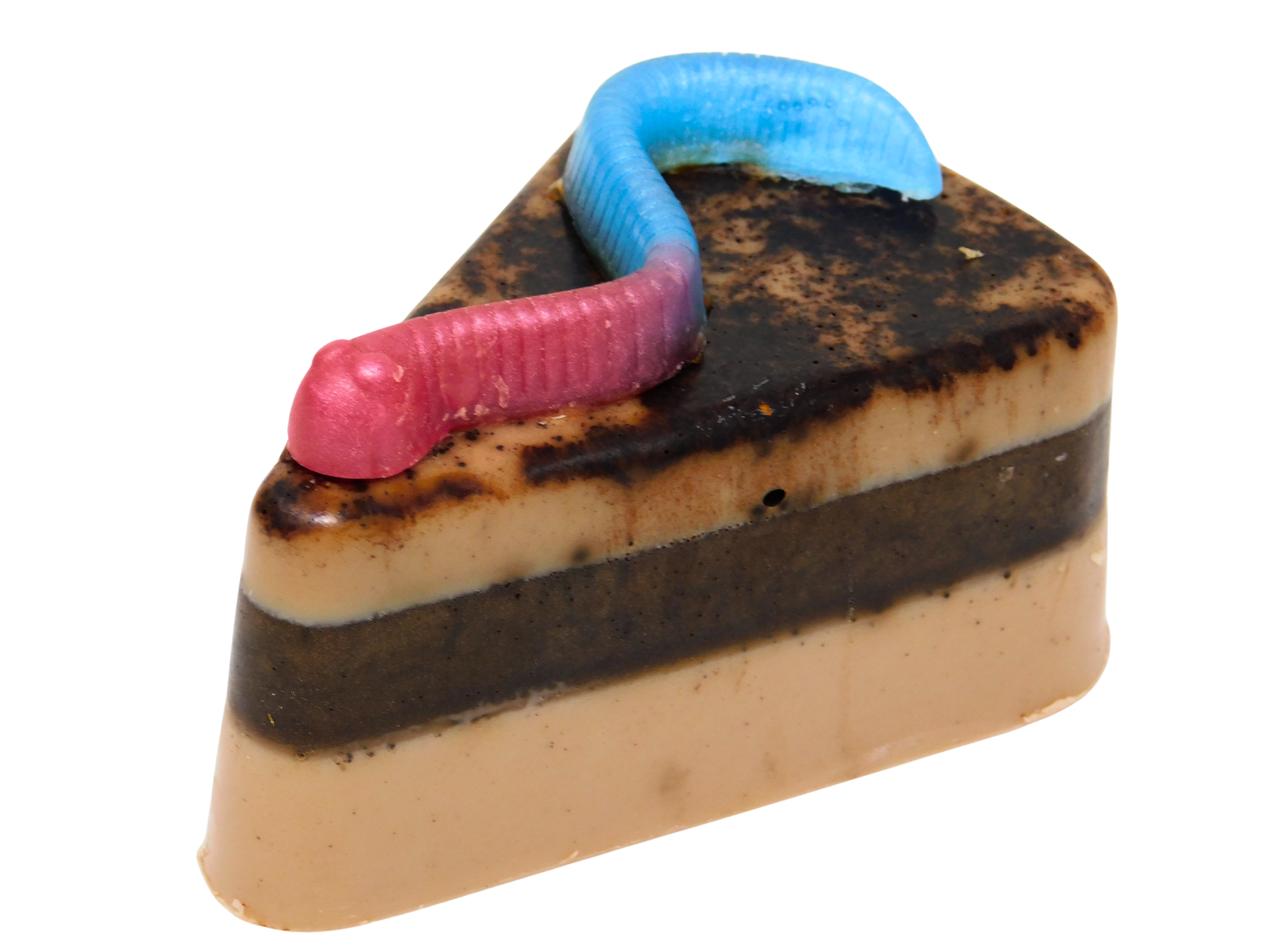 Graveyard Dirt Cake Soap - triangular slice-shaped soap with layered chocolate and caramel tones, real cocoa topping, and a pink and blue gummy worm embed on top, on a white background