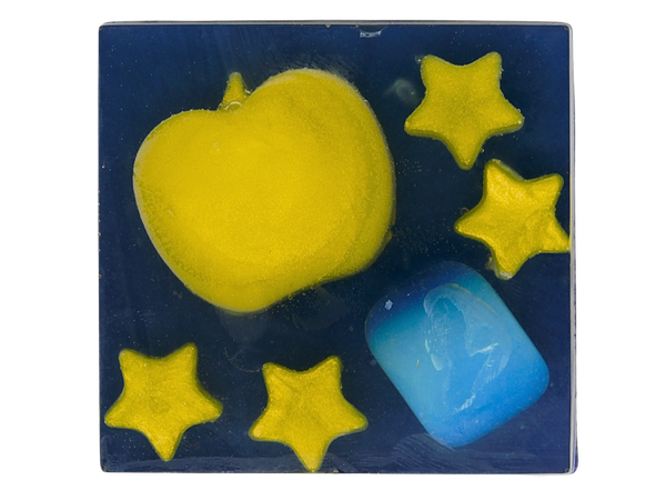 Opal Apple Soap top-down view - deep midnight blue square soap with a yellow heart-shaped apple embed, five yellow star embeds, and a tumbled blue Opalite crystal, on a white background