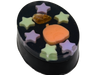 Pumpkin Spell Soap angled view showing the depth of the black oval bar with purple and green star embeds, orange pumpkin, and fire agate crystal on top