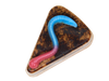 Graveyard Dirt Cake Soap - triangular slice-shaped soap with layered chocolate and caramel tones, real cocoa topping, and a pink and blue gummy worm embed on top, on a white background