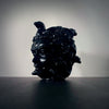 Shadowy image of a black obsidian medusa head