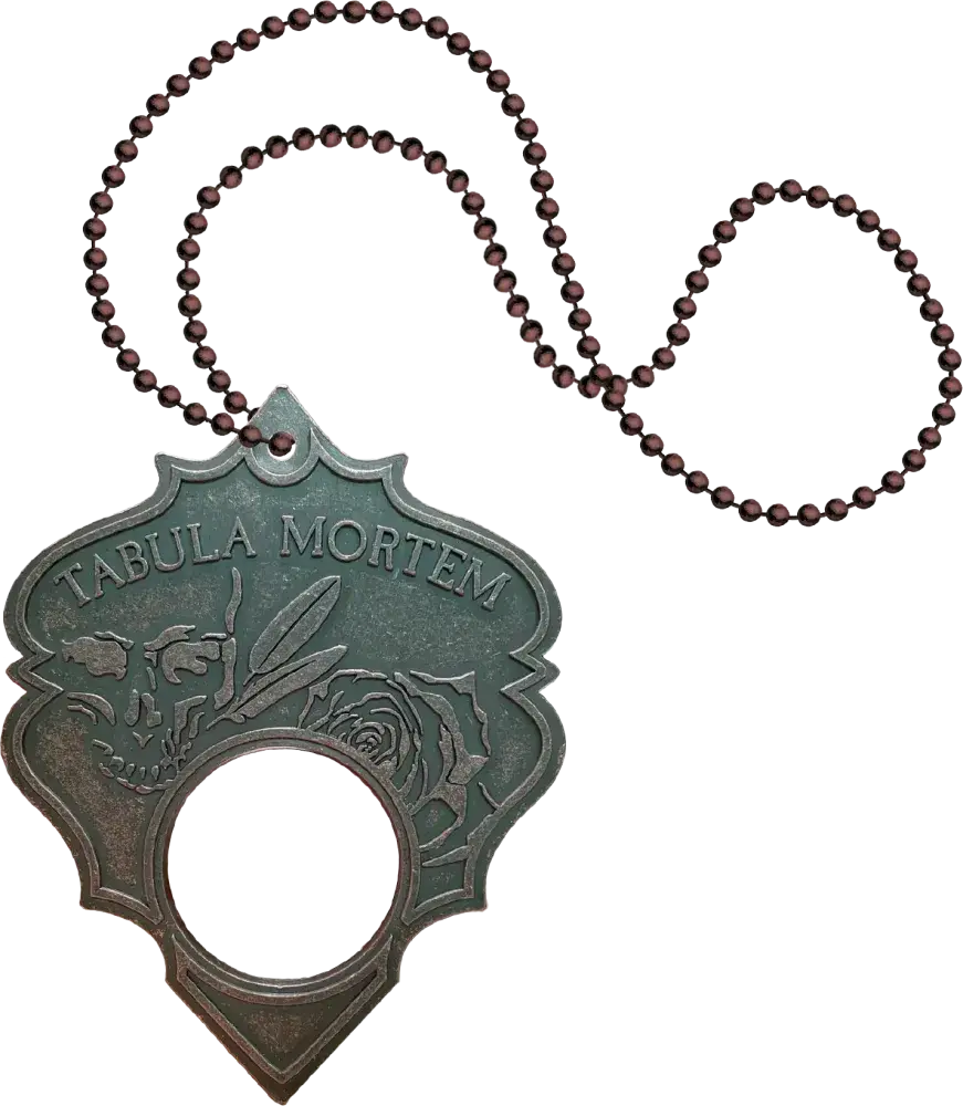 Decorative pendant with 'Tabula Mortem' text and beaded chain on a white background