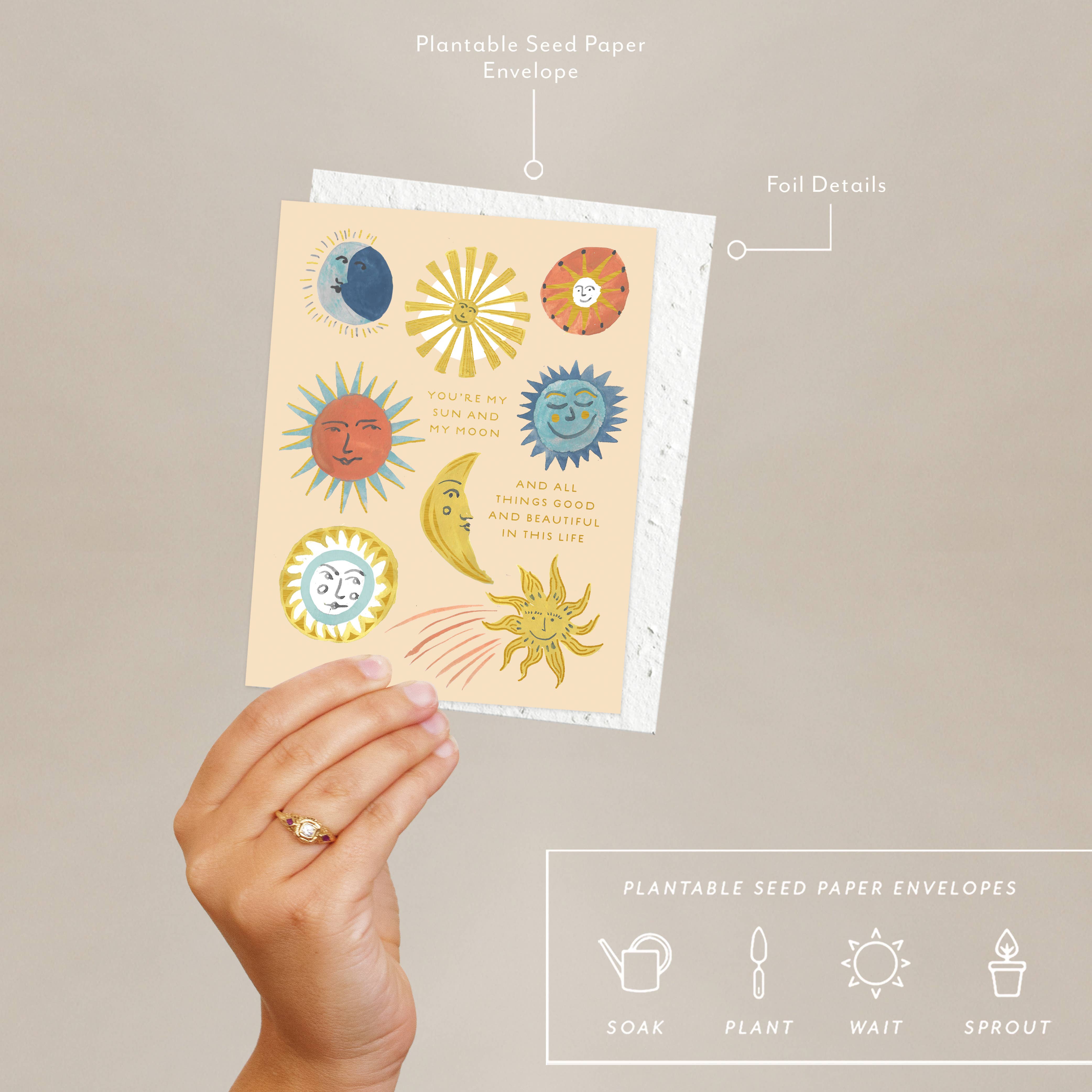 Hand holding a card with sun and moon designs, labeled as 'Plantable Seed Paper Envelopes'.