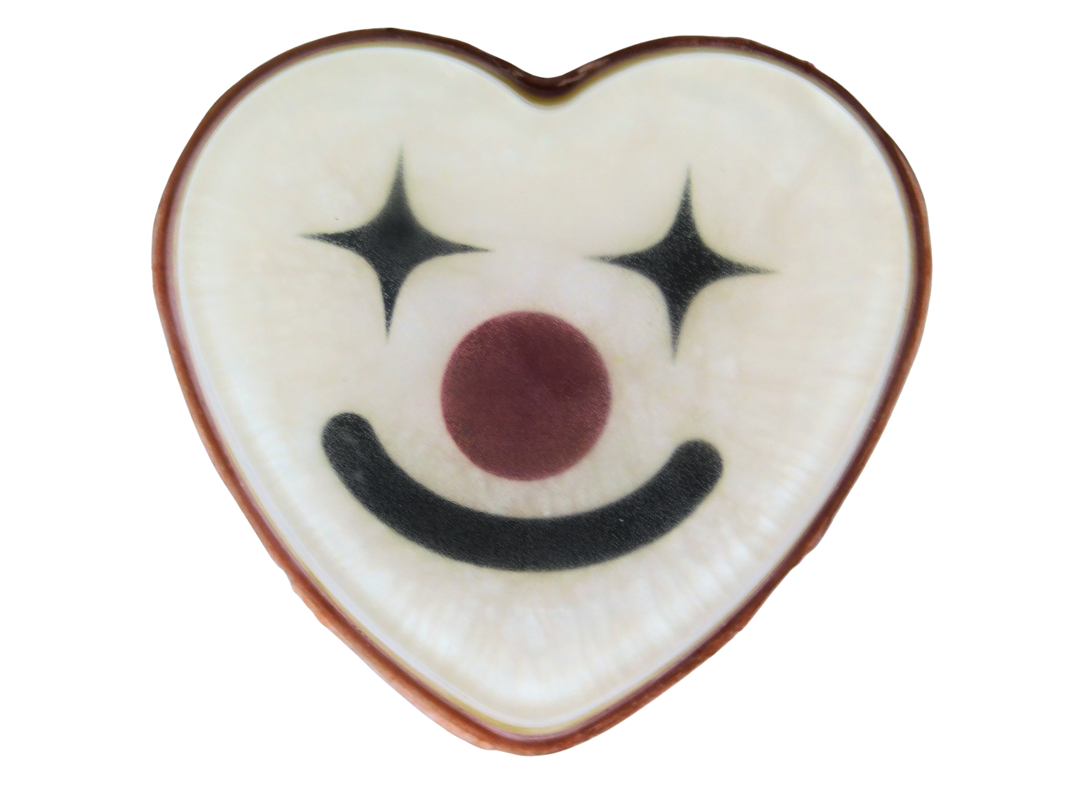 Funhouse Soap top-down view - white heart-shaped soap with a clown face design featuring black four-pointed star eyes, a dark red nose, and a black smile, with a red edge, on a white background