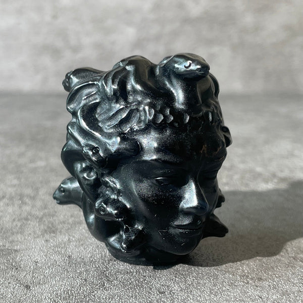 Black obsidian Medusa head, looking right