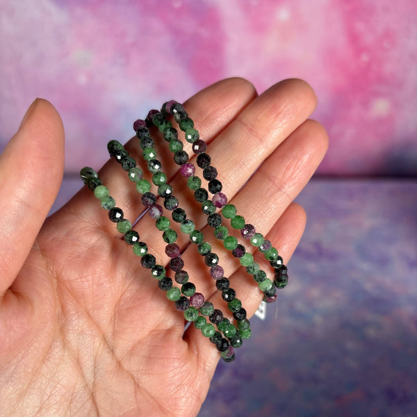 Petite bracelets held by a hand