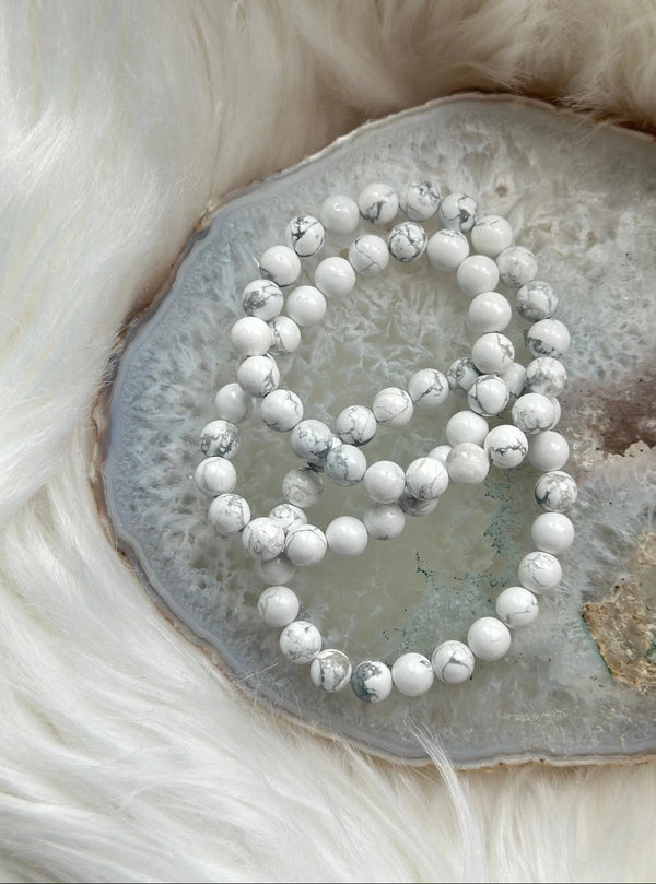 Howlite bracelets sitting on an agate and fur