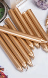 Gold chime candles laid out in a row