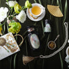 A tasteful arrangement of teas, flowers, and beautiful little trinkets