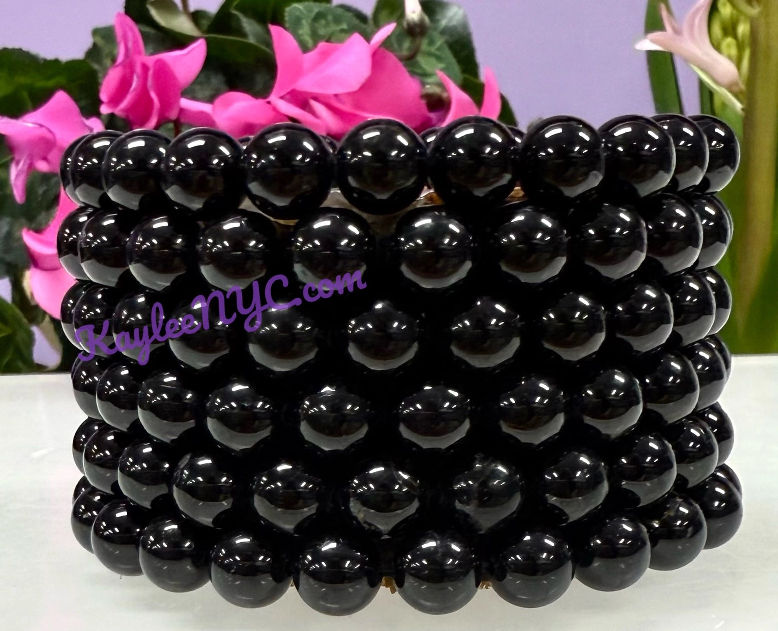 Black beaded bracelets stacked together