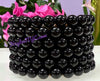 Black beaded bracelets stacked together