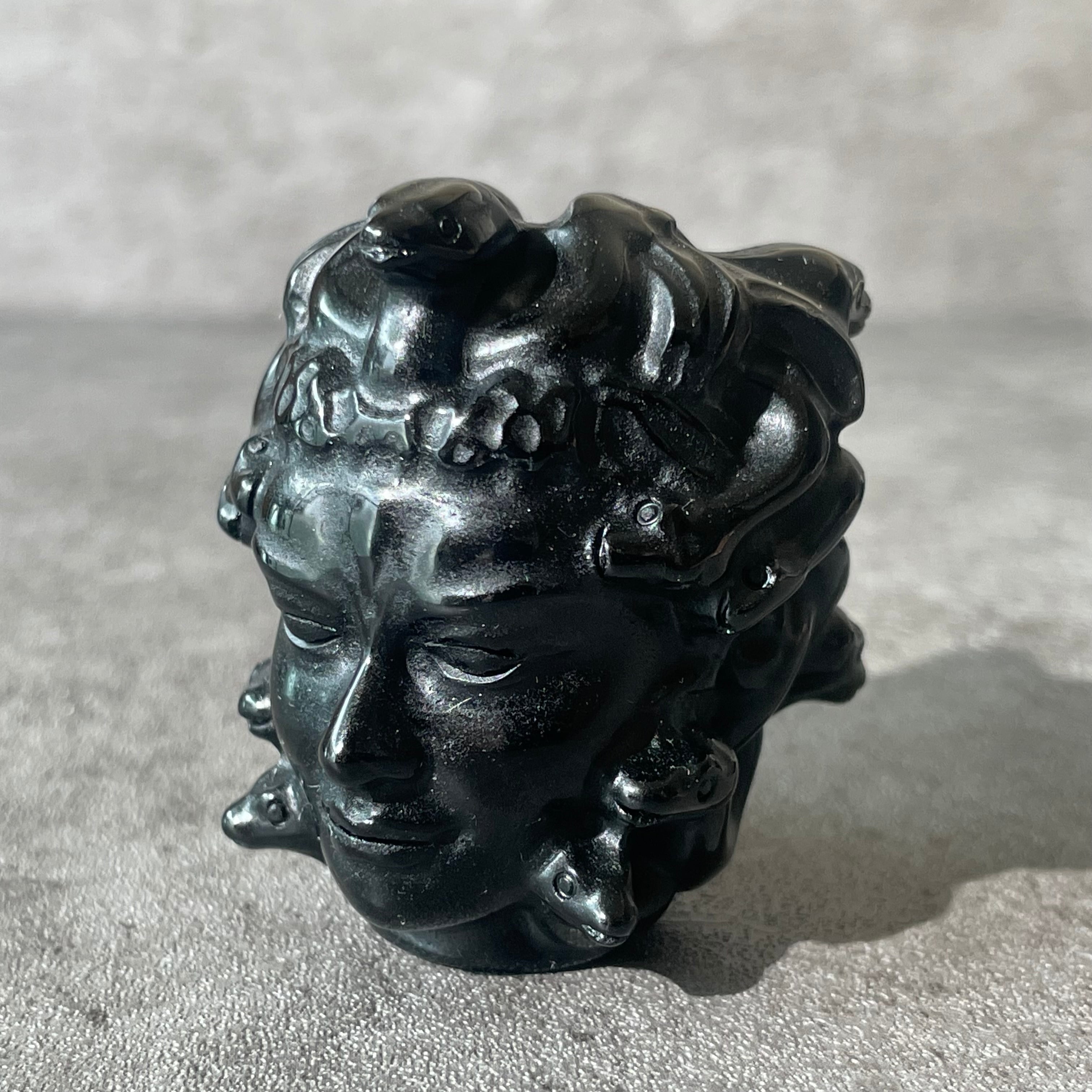 Black obsidian Medusa head, looking left
