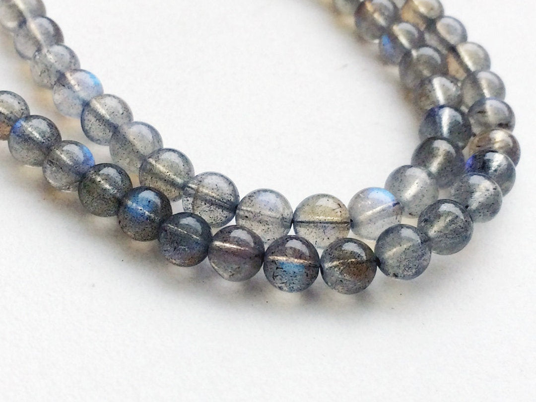 Two strands of labradorite beads showing flecks of grey and blue flash
