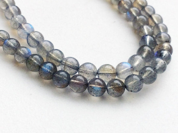 Two strands of labradorite beads showing flecks of grey and blue flash