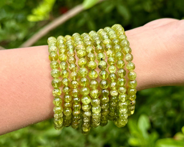 A whole wristful of peridot bracelets