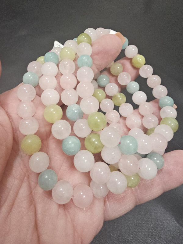 A handful of pastel Peace and Love bracelets