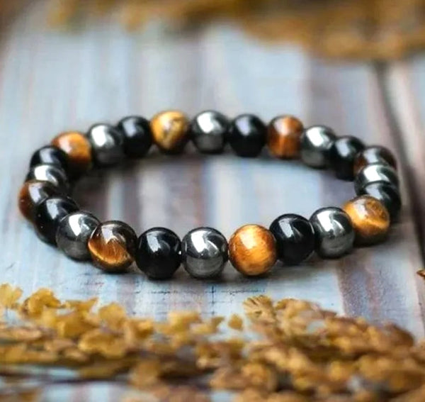 One stretch bracelet with three different protection crystals; tiger's eye, hematite, and onyx