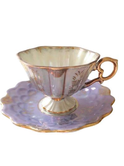 An ornate vintage-style teacup and saucer set. The cup features a pale lavender-purple exterior with gold trim, a cream-colored interior, and a decorative gold handle.